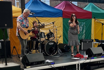 A singer and musicians performing at Blast Off 2026