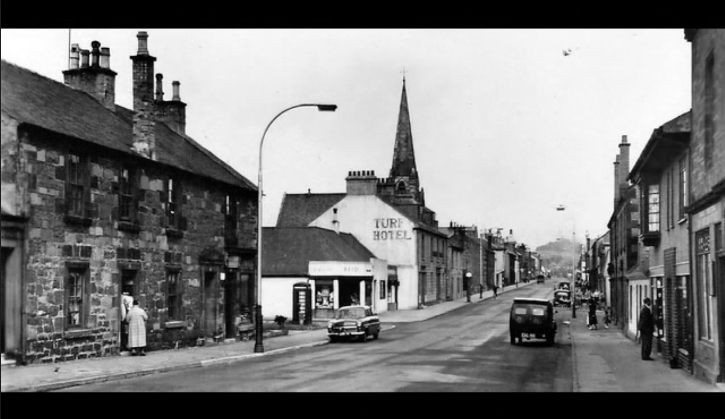 Main Street looking towards the Turf Hotel and church spire. Date unknown.